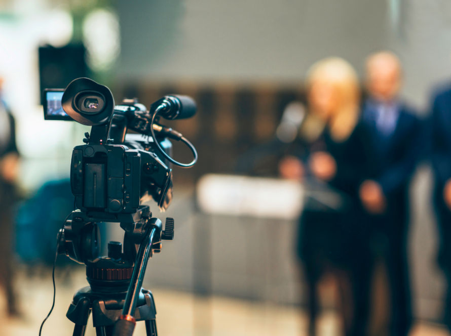 reporter talking to a video camera